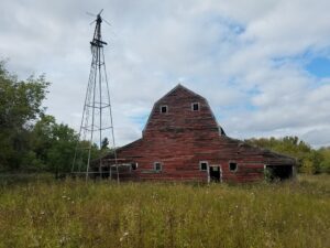 An old barn with a windmill.